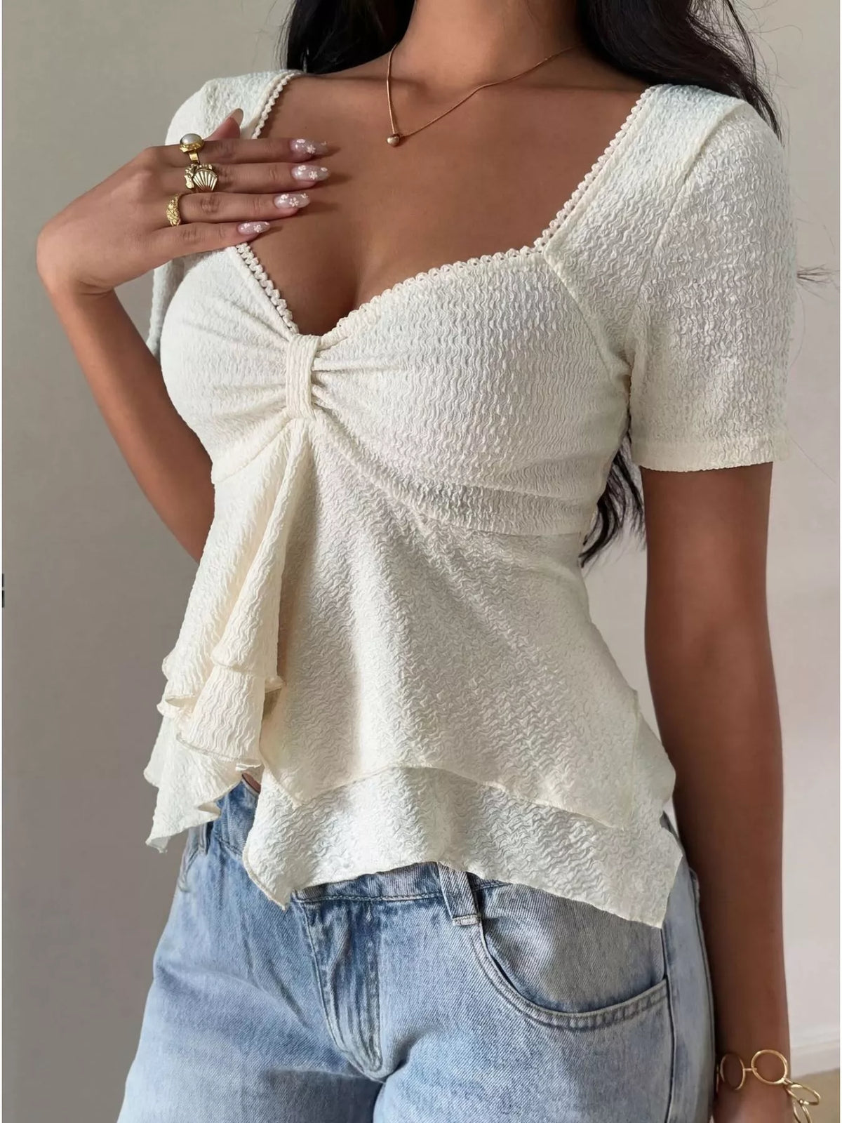 Close up of the layered ruffle sleeve on the white top