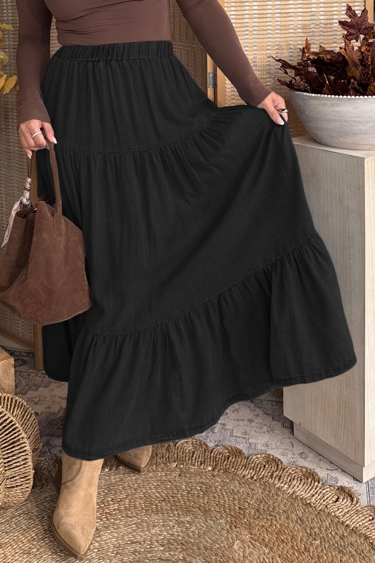 Ruffled hem detail of tiered denim maxi skirt