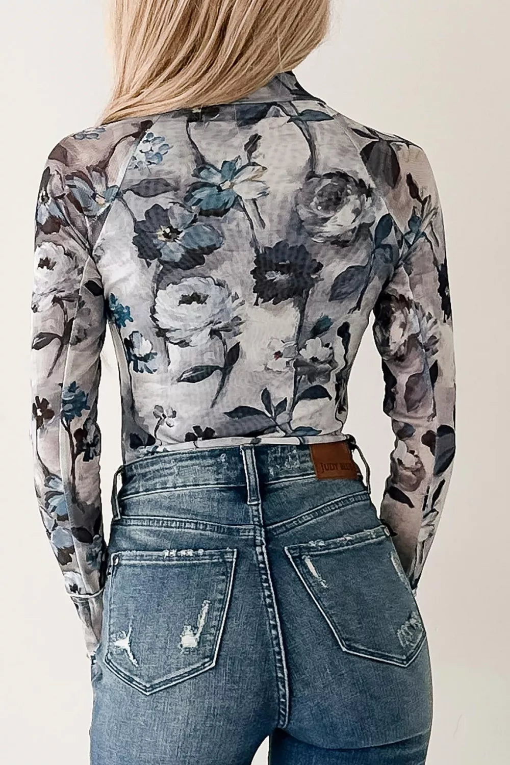 Back view of the floral mesh long sleeve top
