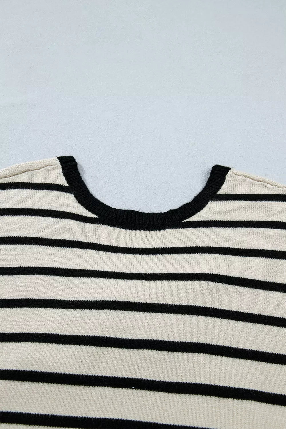 Black bow applique sweater fabric detail