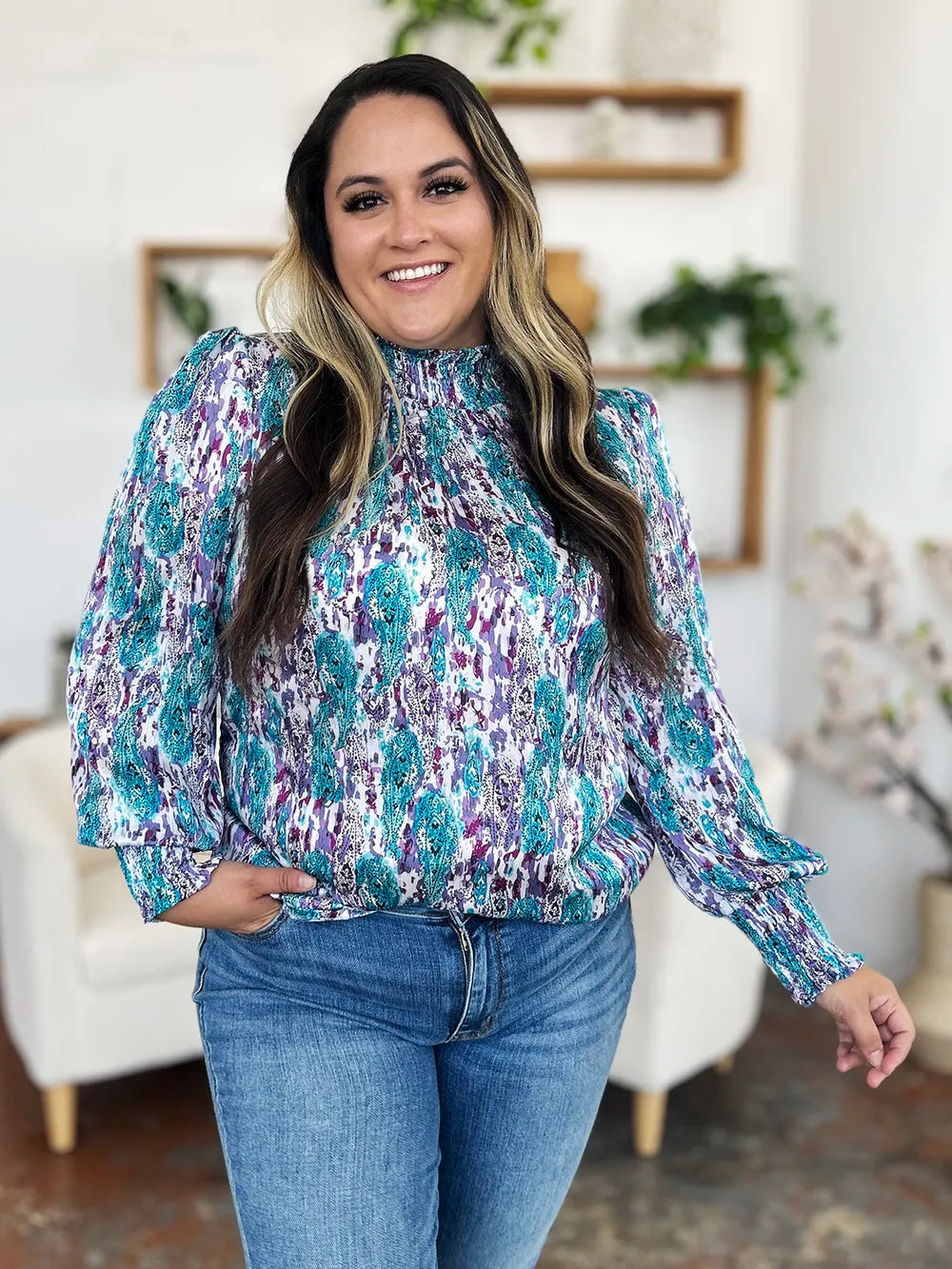 Seated view of the printed smocked blouse