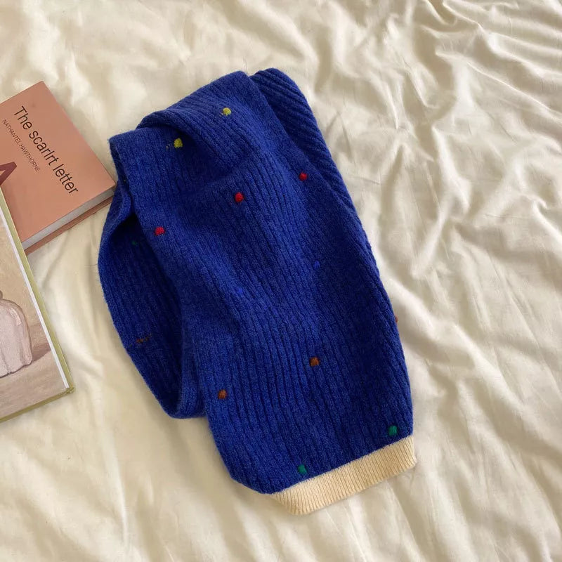 Colorful dot knitted scarf shown at full length