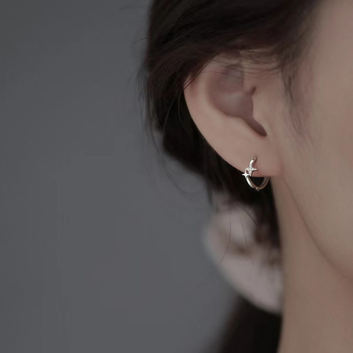 Sterling silver star hoop earrings shown as a pair