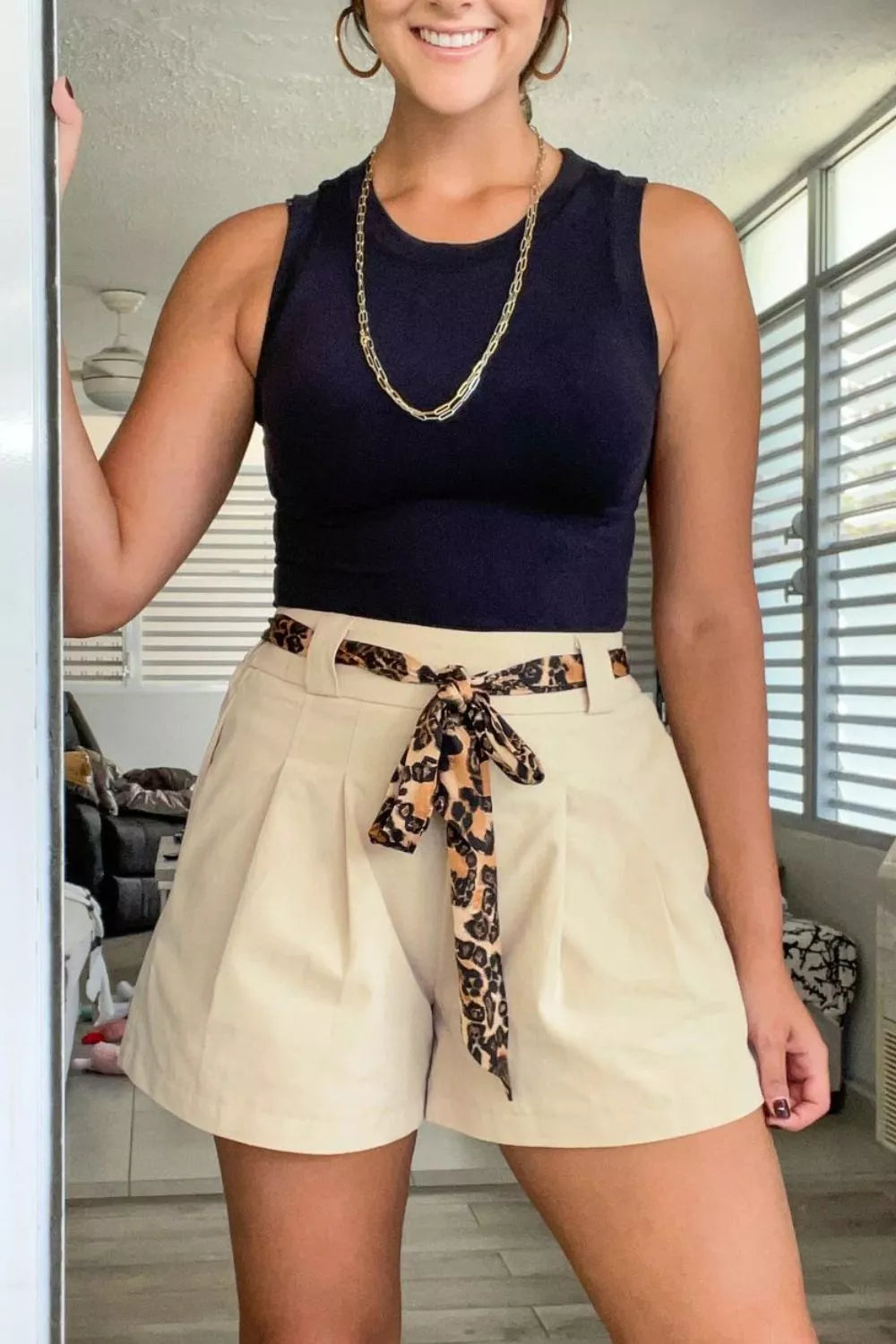 Beige high waisted pleated shorts styled view