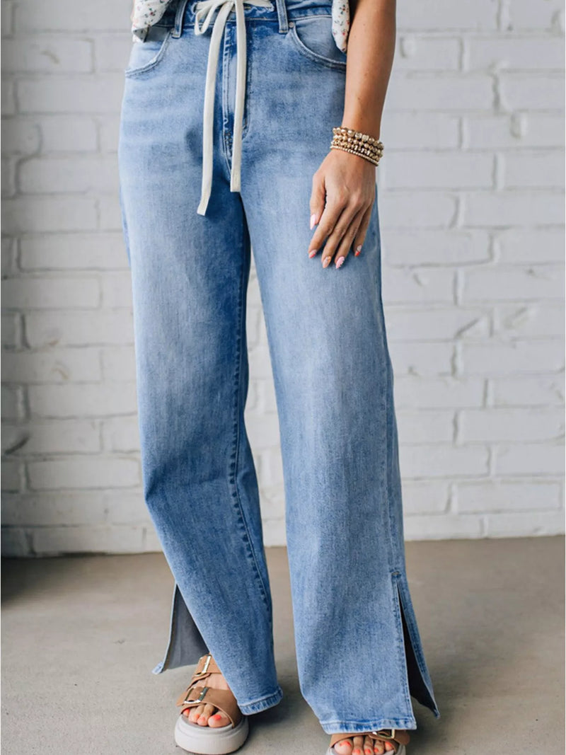 Medium wash slit hem wide leg jeans front view