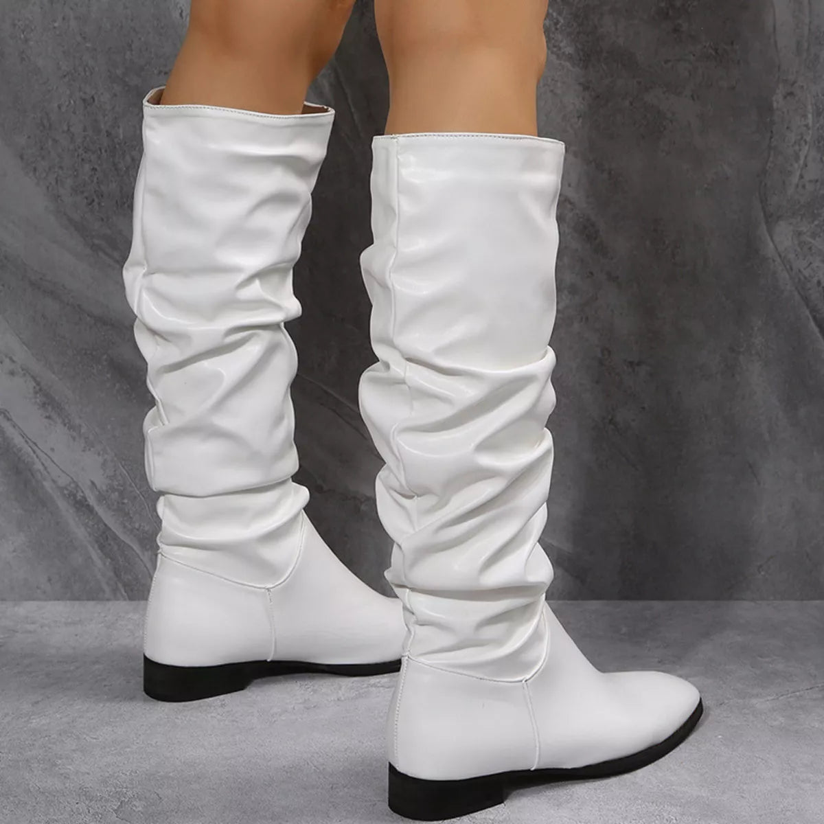 White slouchy block heel boots sole view