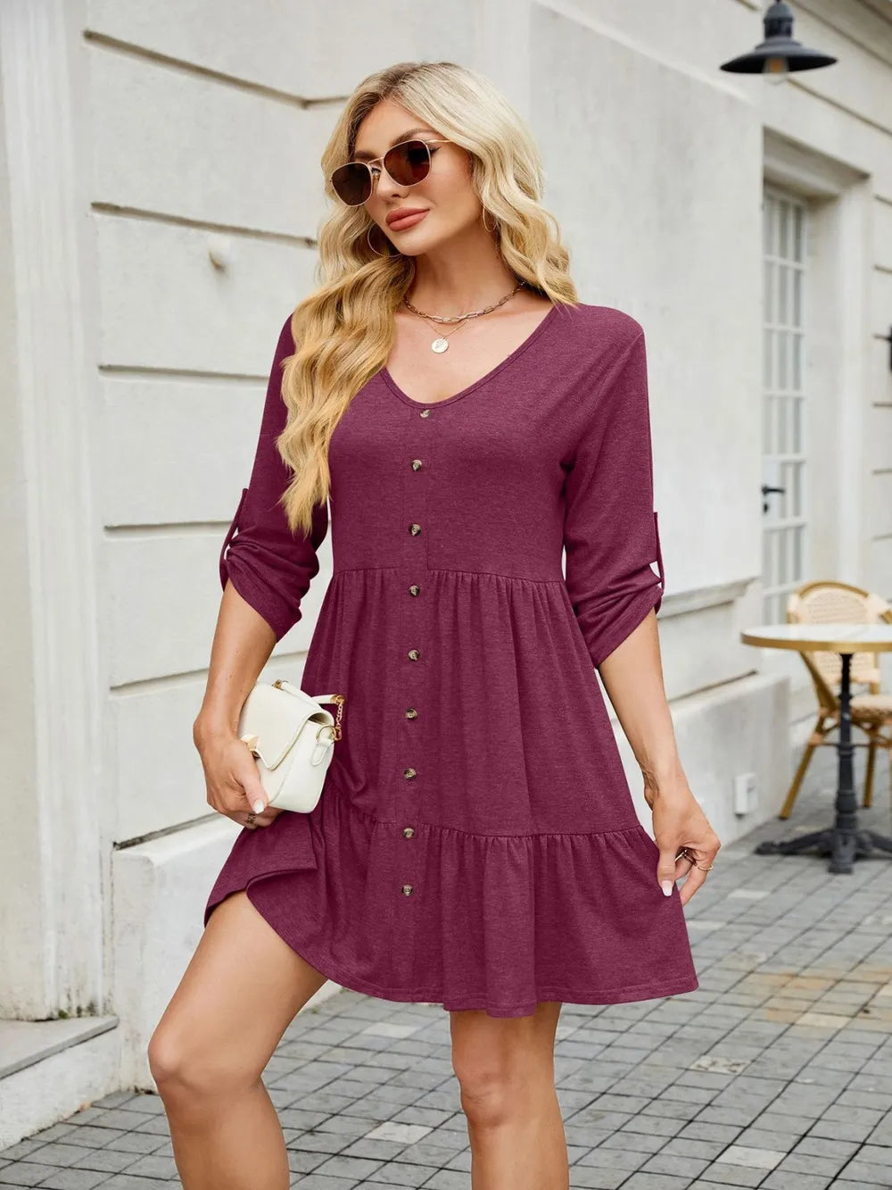 Model wearing tiered V-neck mini dress
