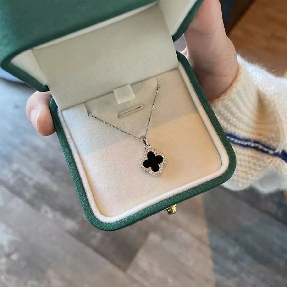 Clover pendant necklace layered with a longer chain