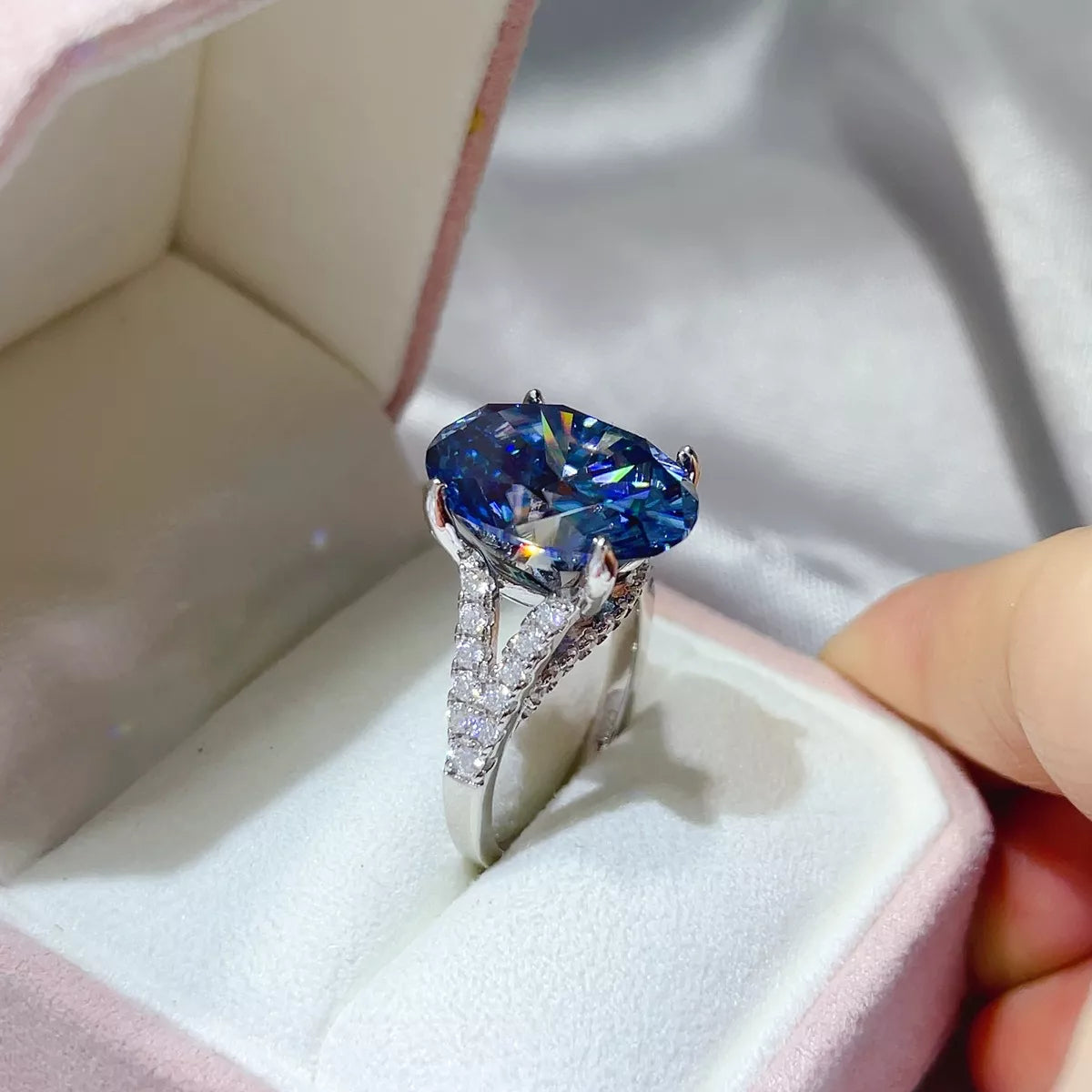Blue moissanite statement ring photographed from above
