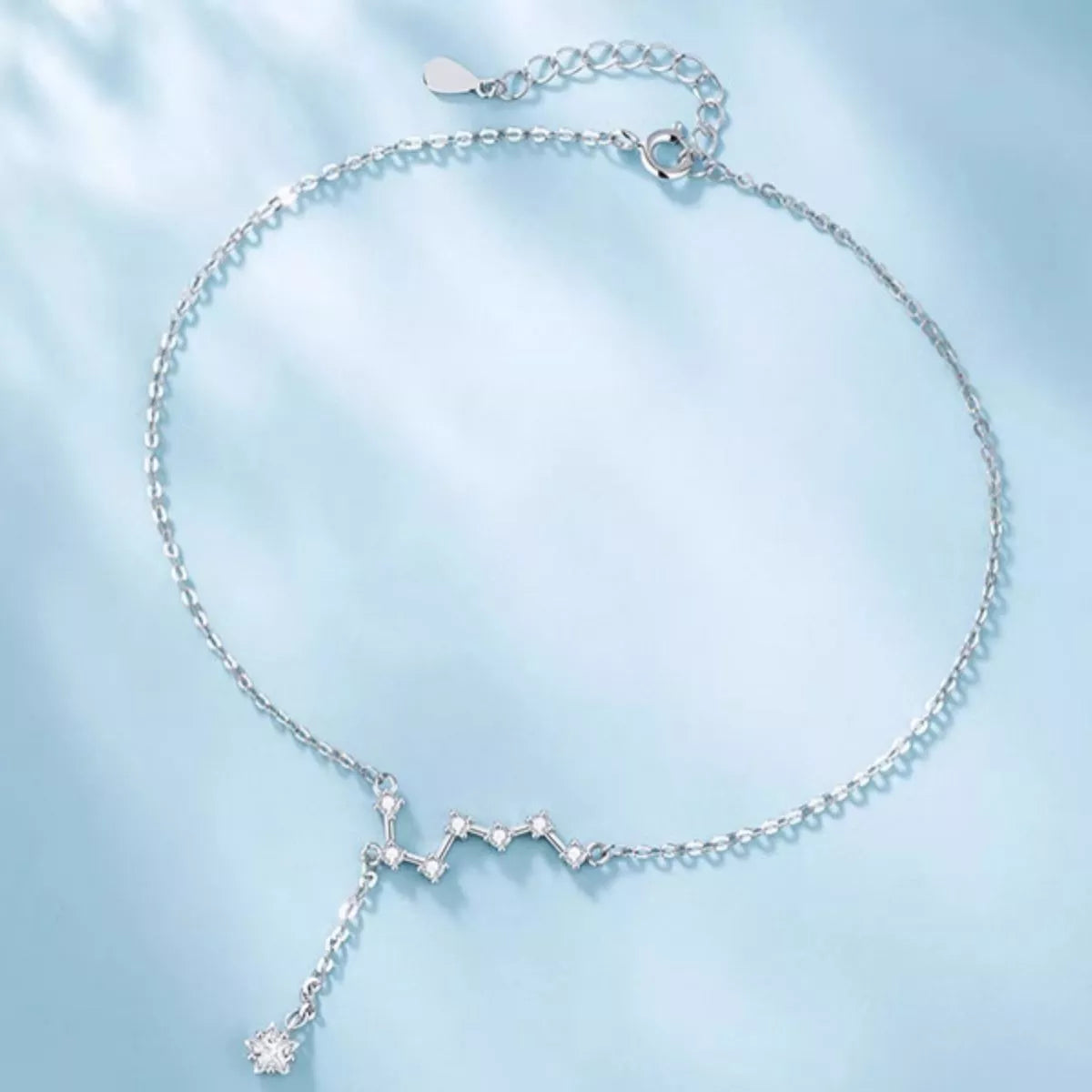 Silver anklet shown laid flat to show chain length