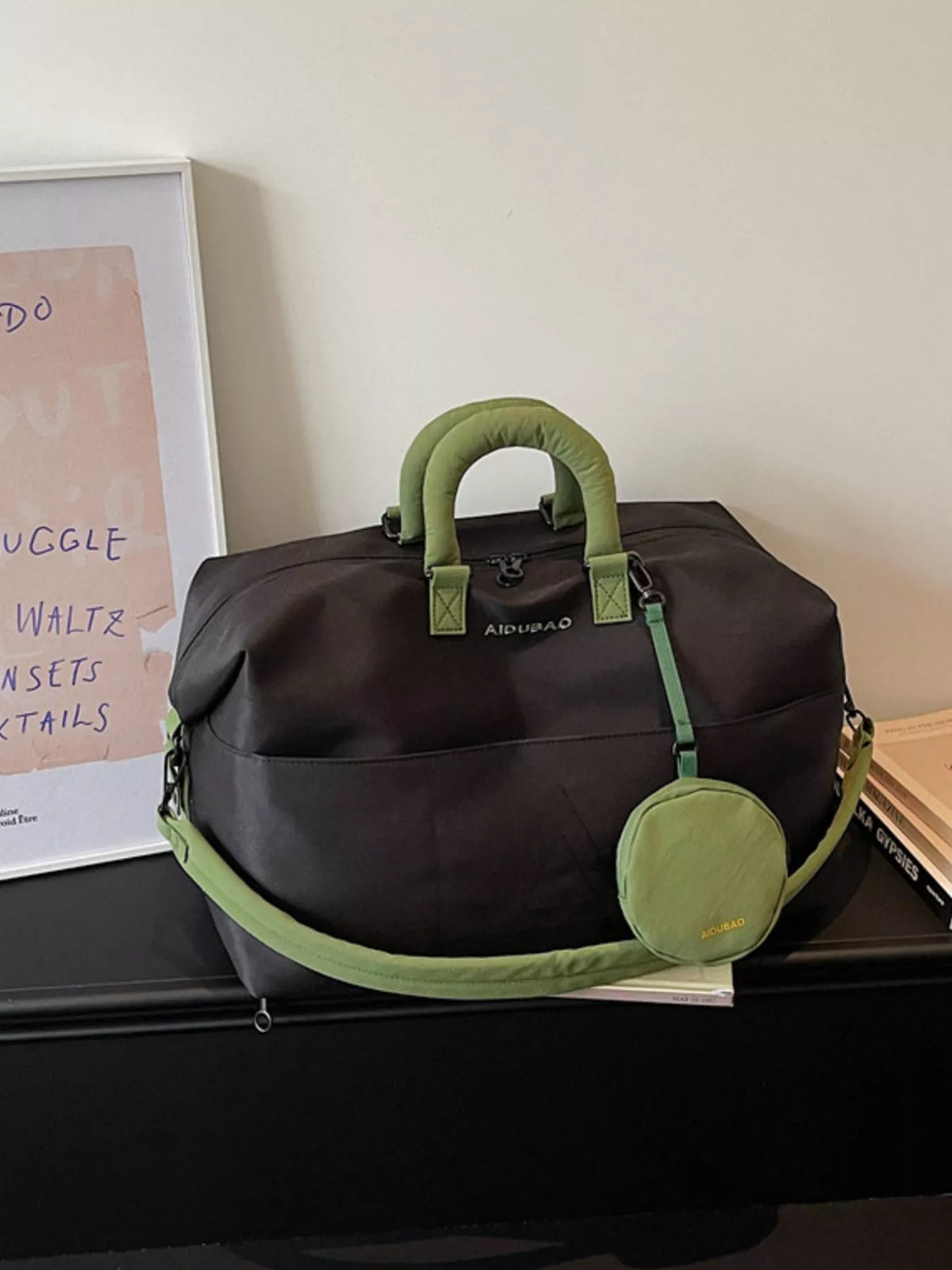Black nylon travel duffel bag with detachable pouch front view