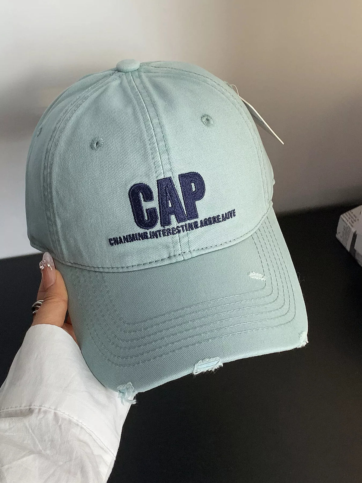 Side profile of the one size distressed cotton cap