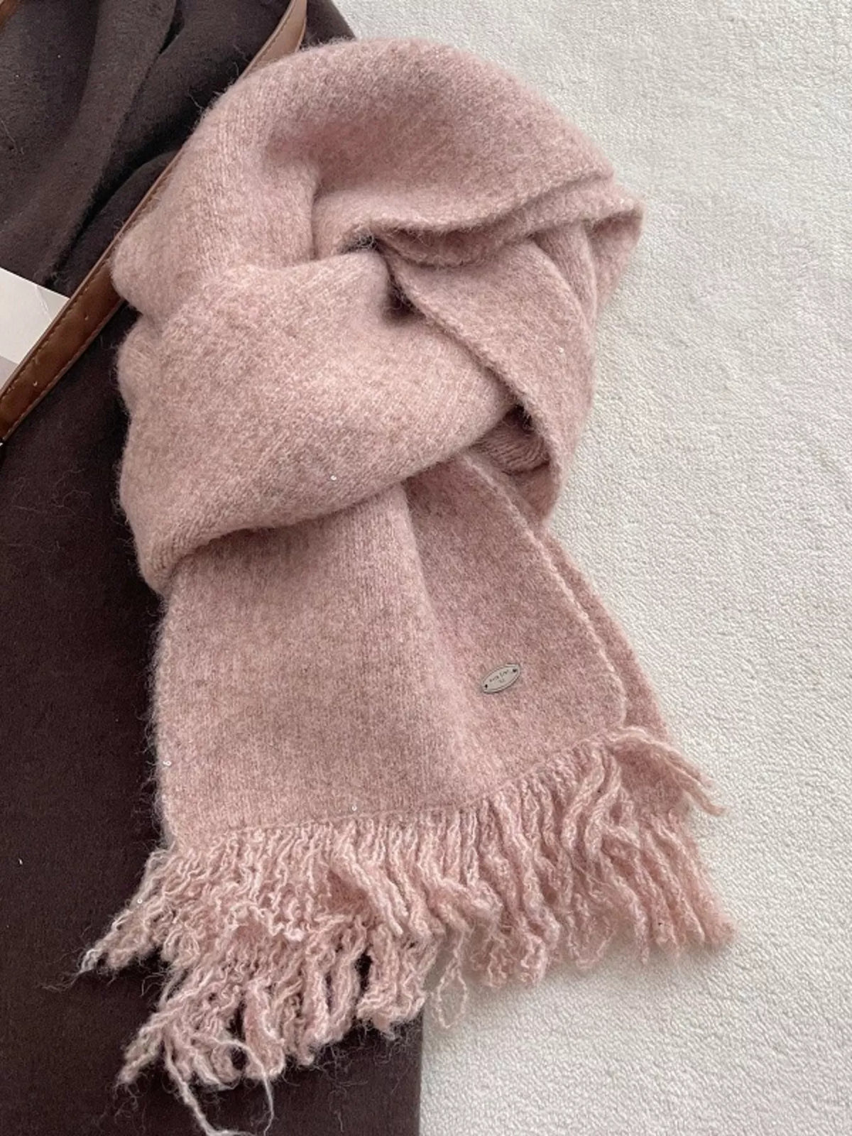 Knitted fringe scarf draped over the shoulders