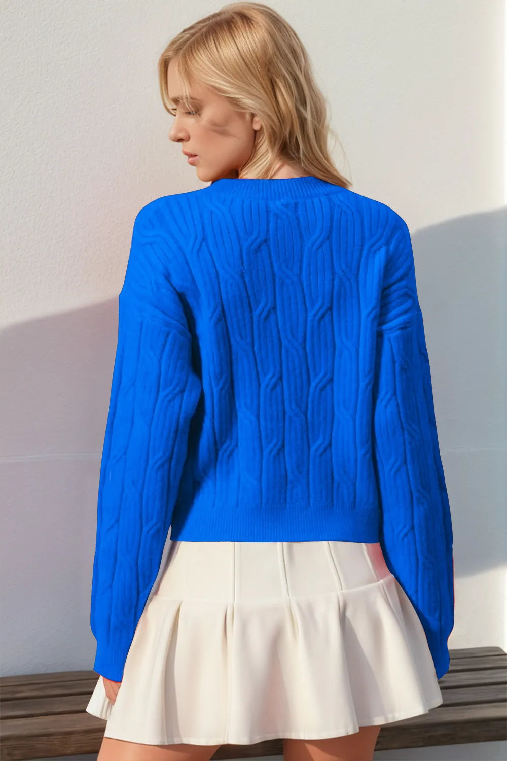 Round neck cable sweater bow close up detail