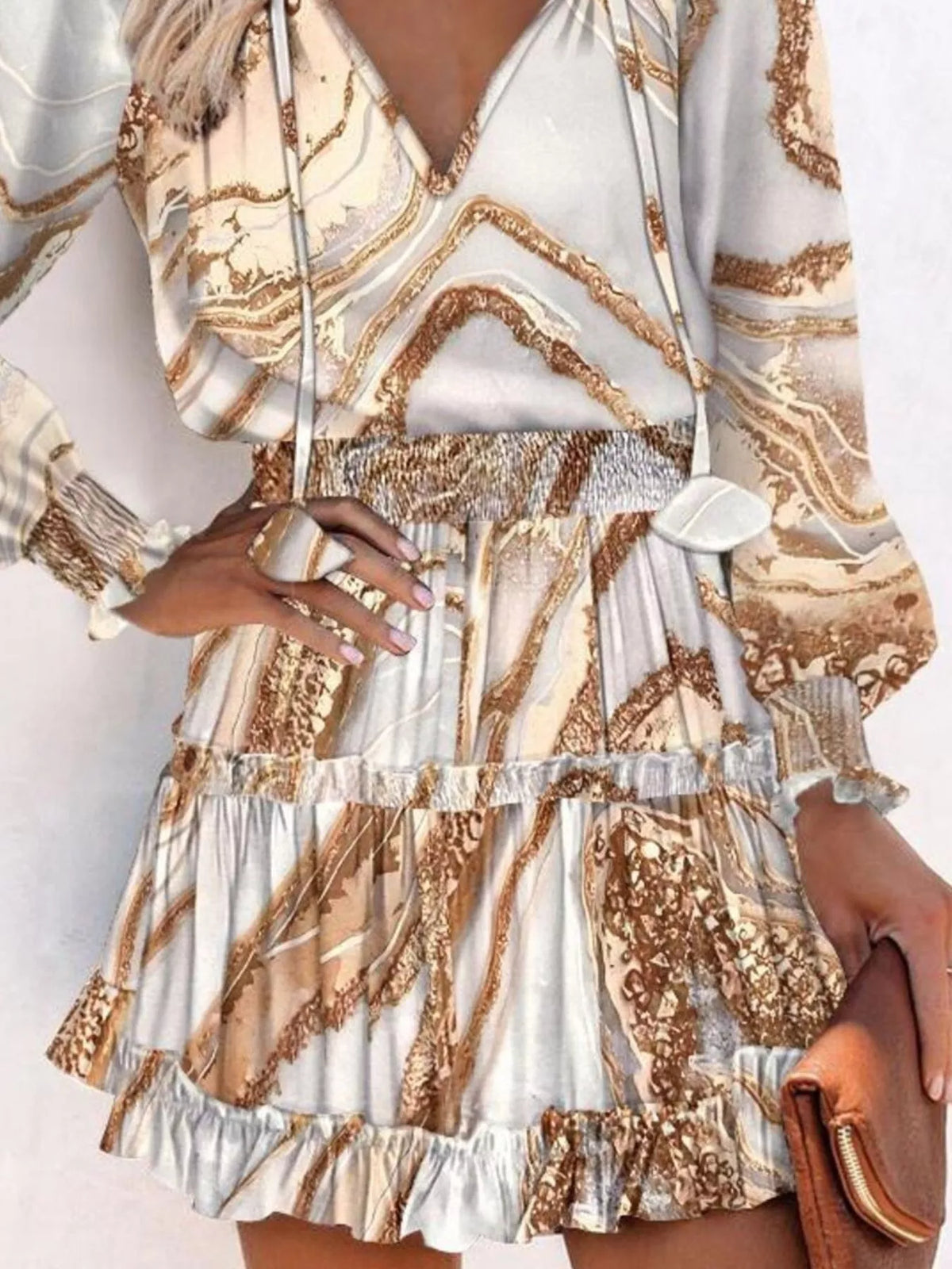 Tie neck lantern sleeve tiered dress close up view