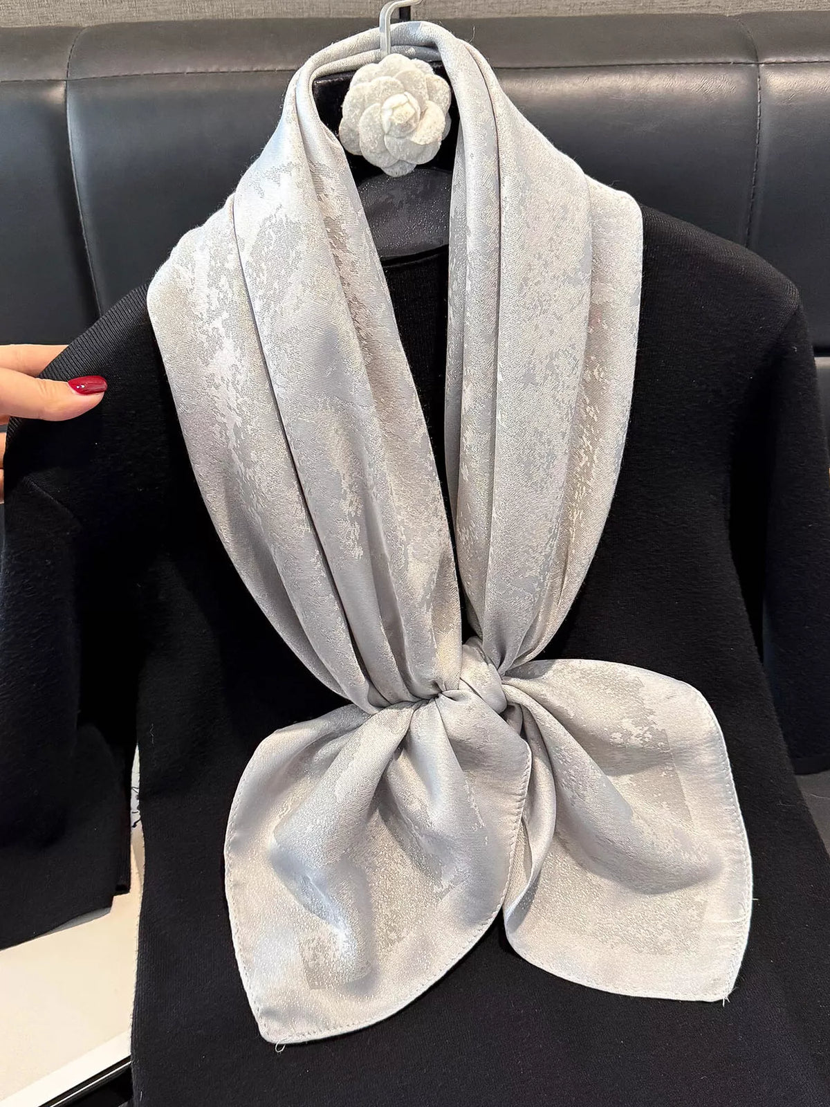 Green silky scarf tied at the neck