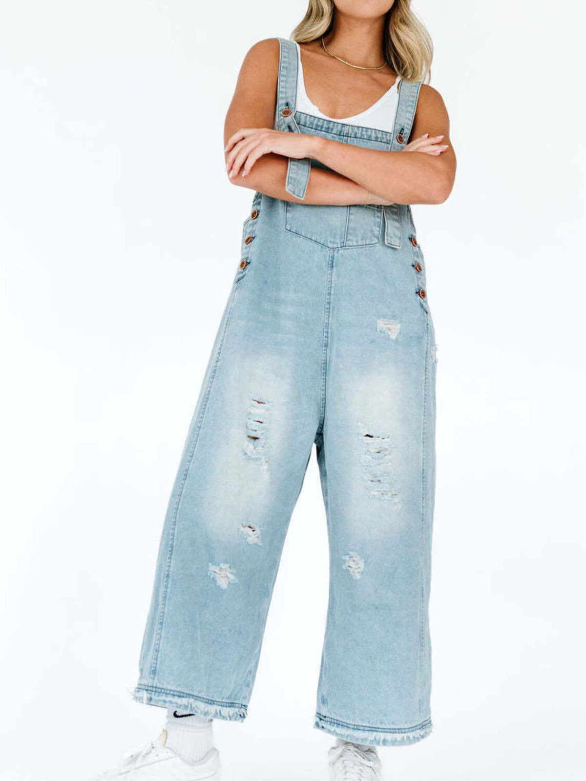 Distressed denim overalls detail shot