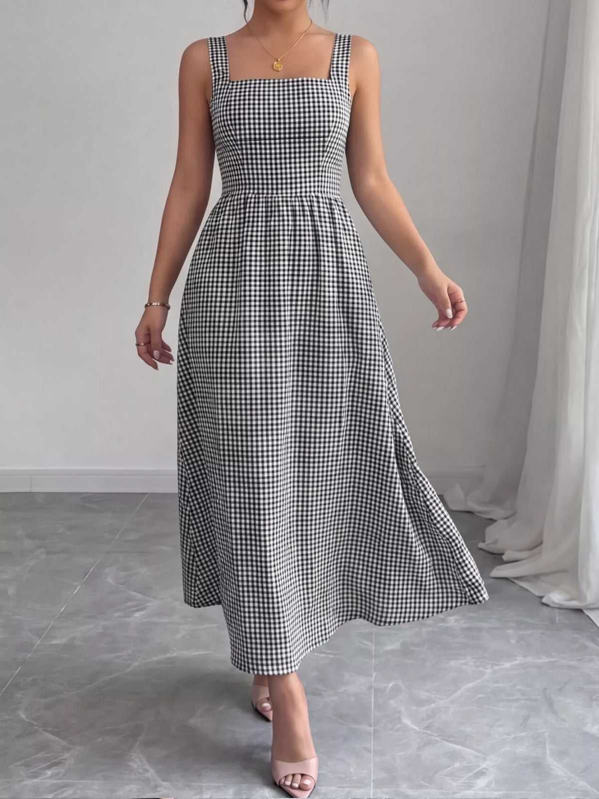Gingham dress shown at a side angle with the pleated skirt
