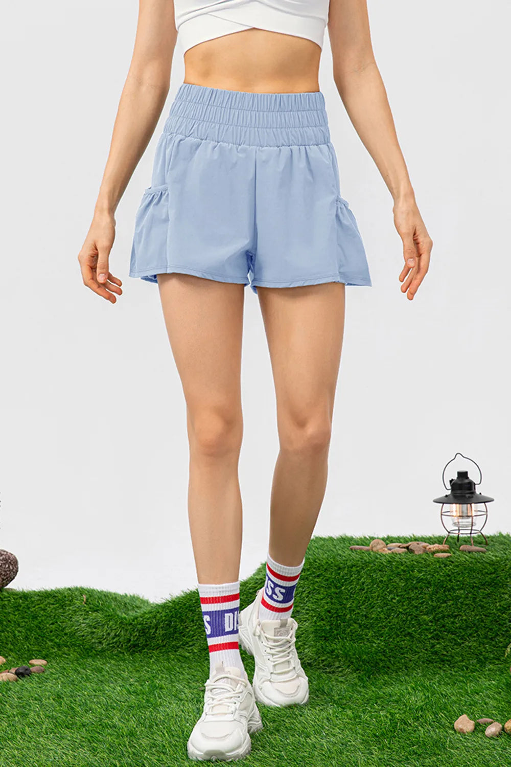 Elastic waist pocketed active shorts seated view