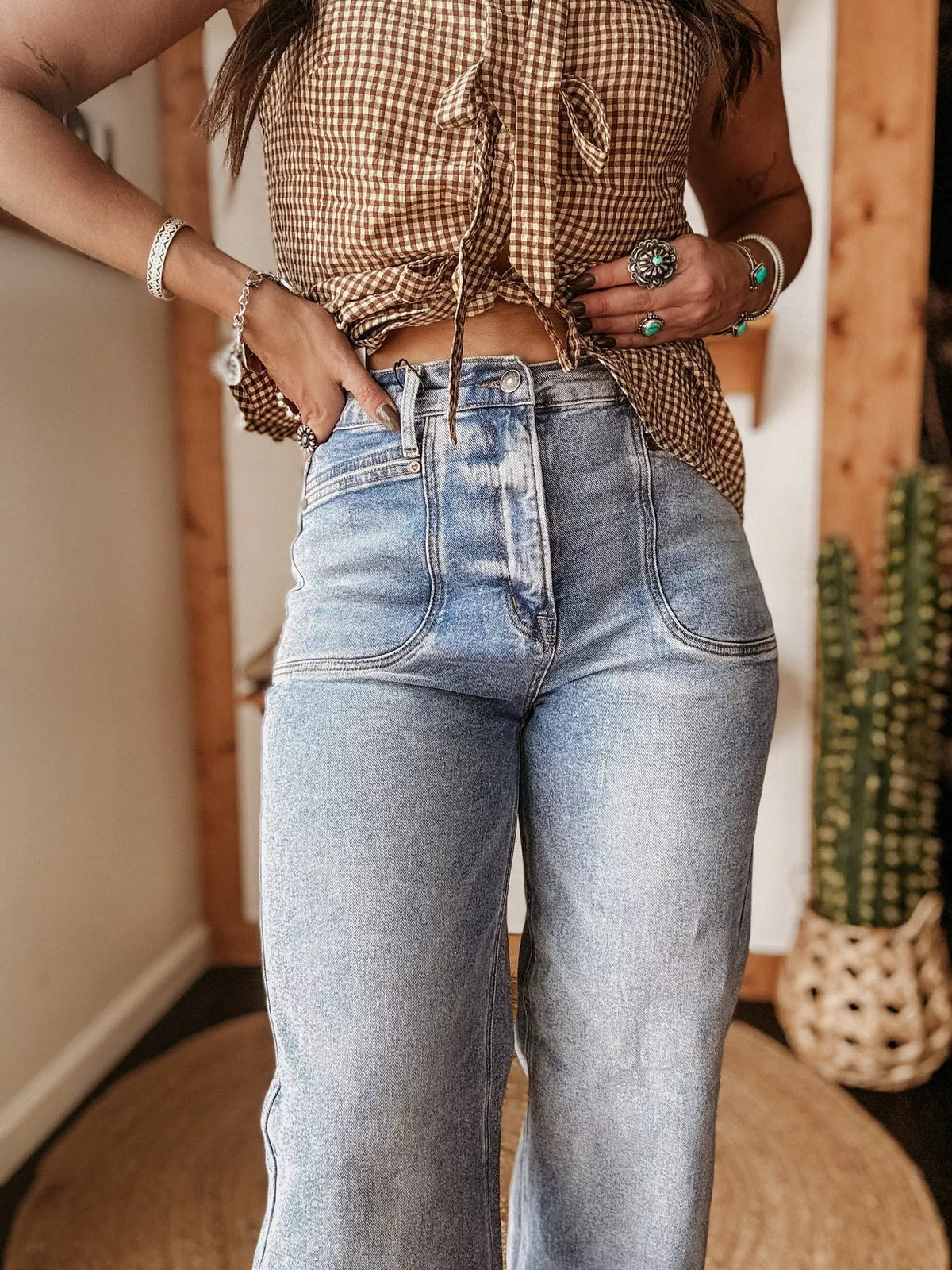 Detail of pocket and waistband on blue wide leg jeans