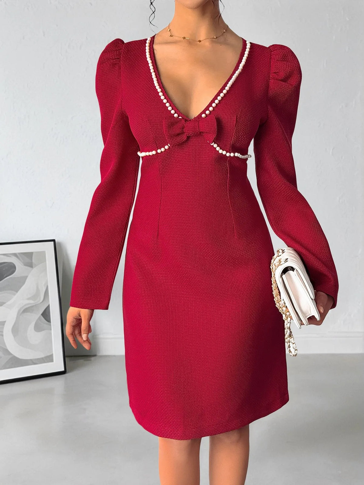 Red pearl trim V neck long sleeve bodycon dress three quarter view