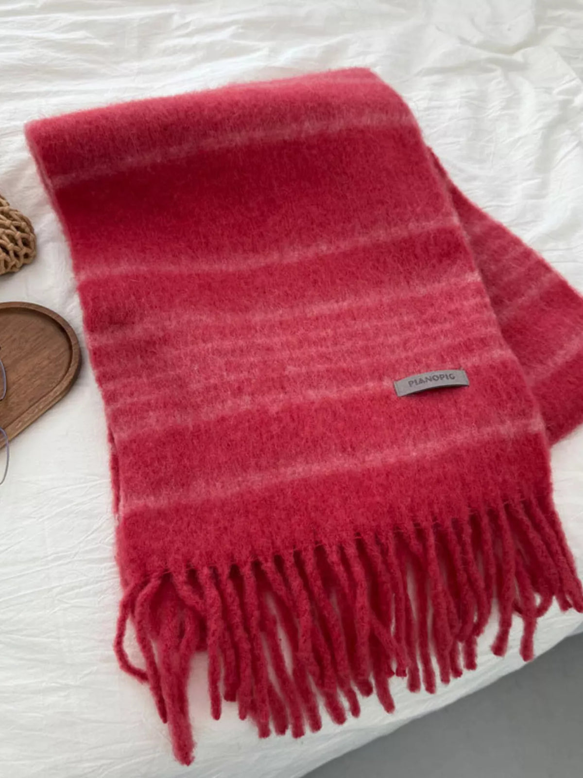 Cozy striped scarf shown with fringe ends visible