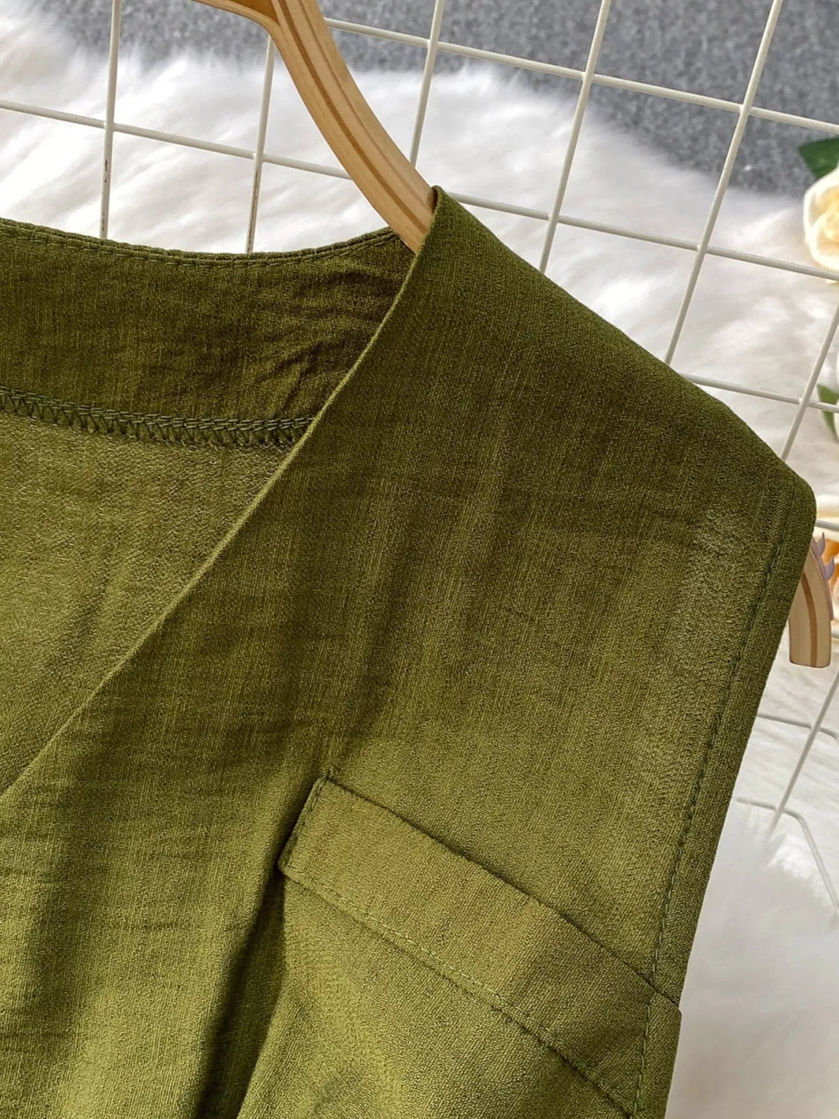Green sleeveless jumpsuit waist belt detail