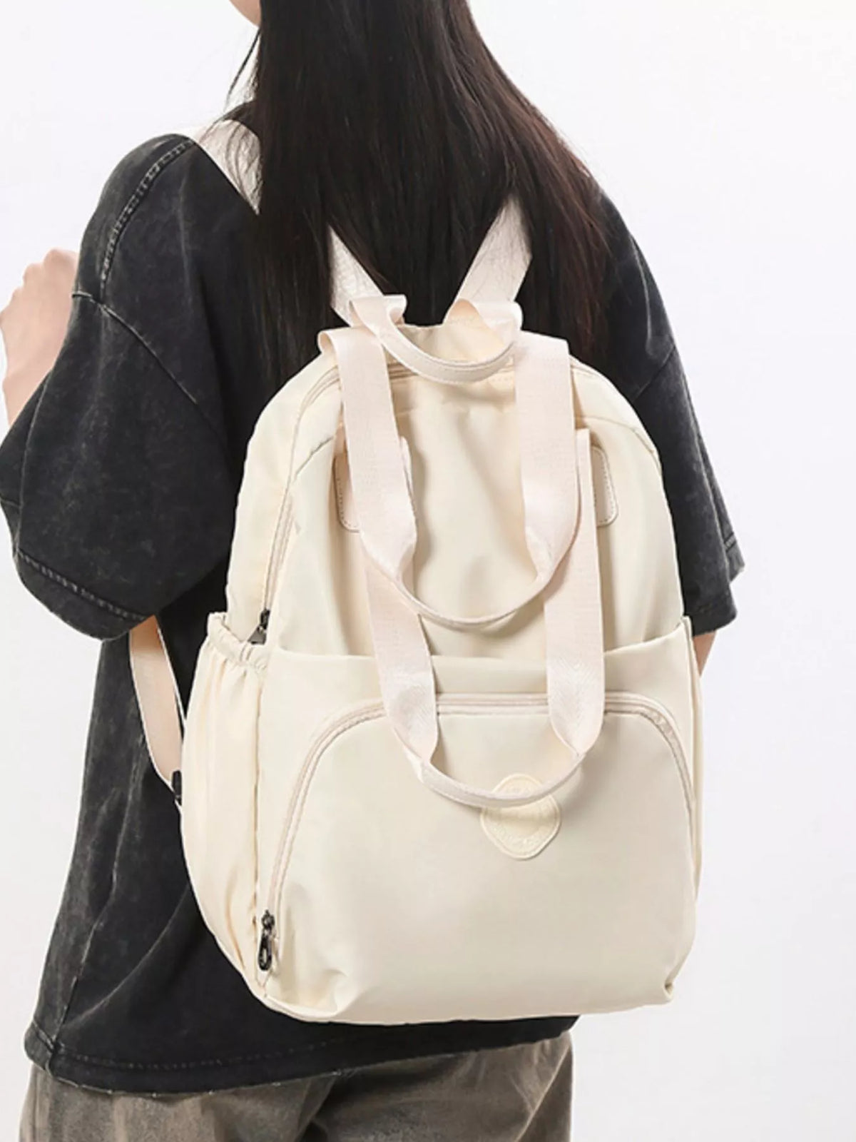 Solid color Oxford backpack worn on the back