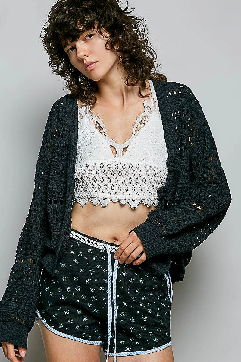 Open knit floral button cardigan in black front view