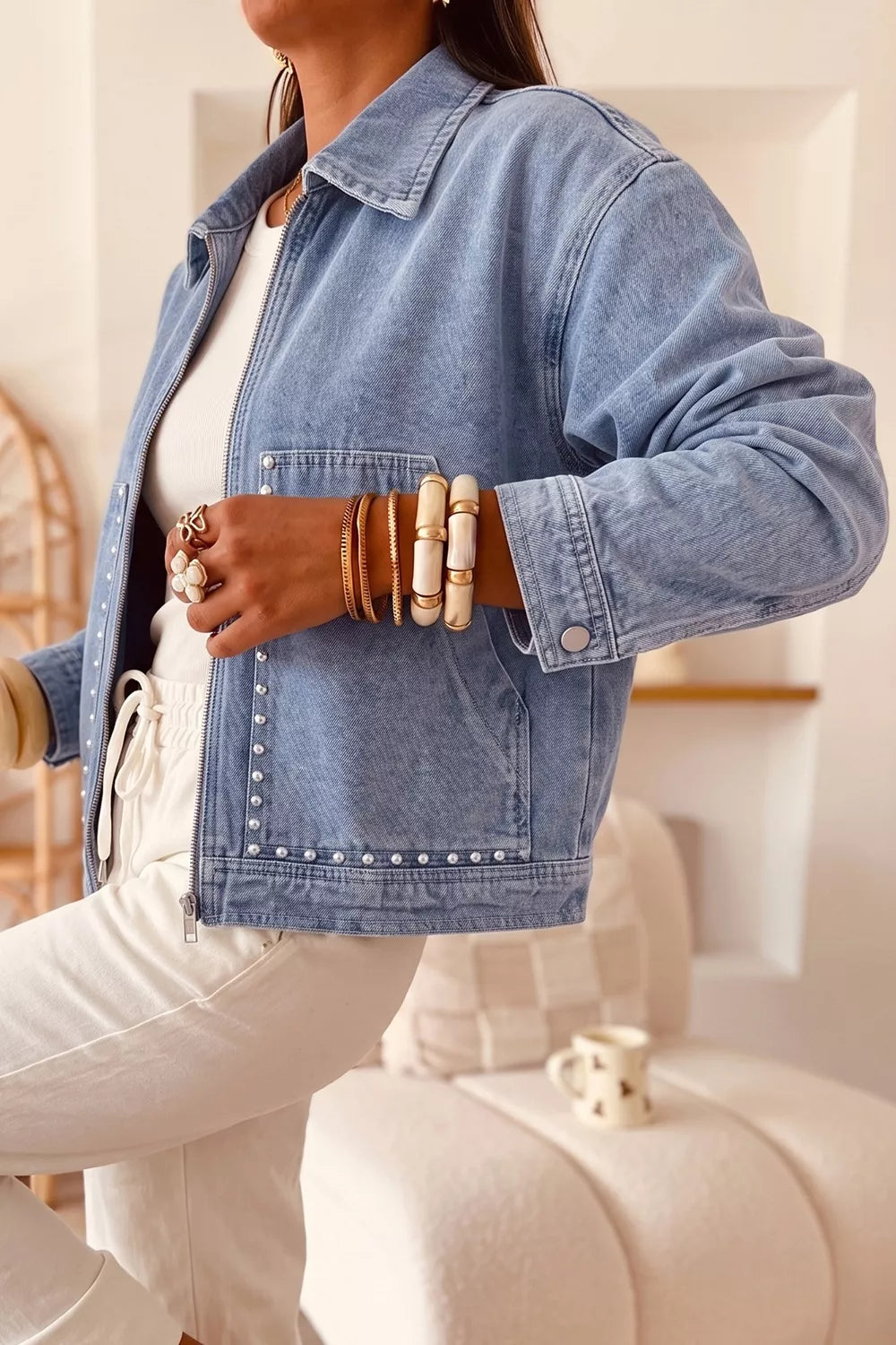 Detail of the zipper and pocket on the denim jacket