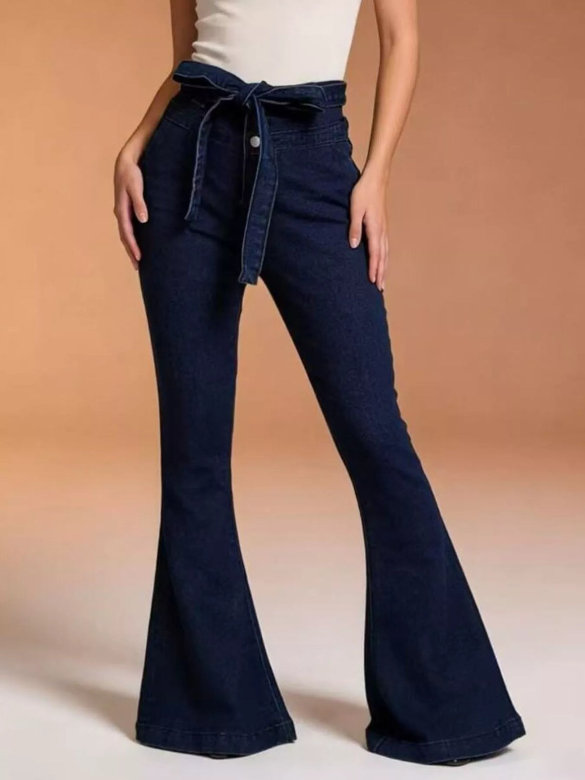 Model wearing bow tie flare jeans