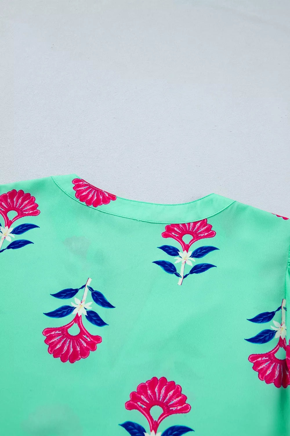 Turquoise floral V neck flutter sleeve blouse side view