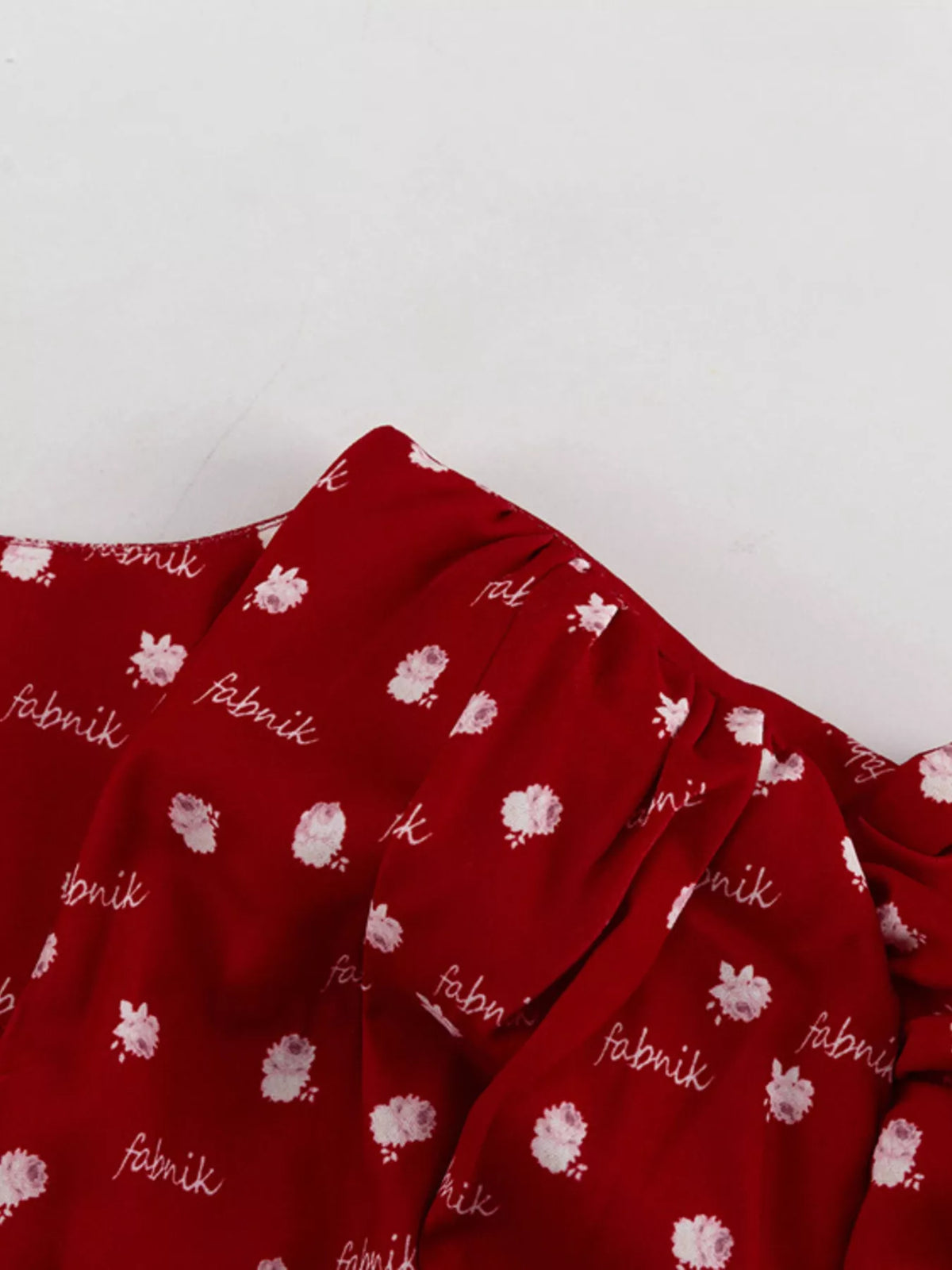 Neckline detail of the polka dot long sleeve dress