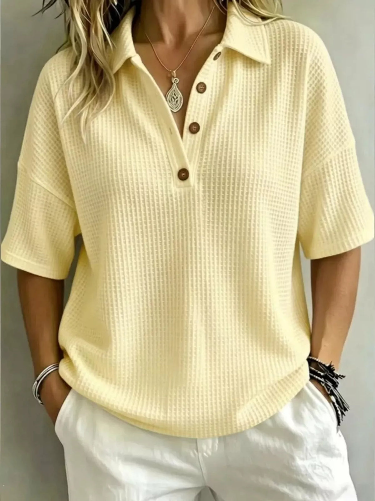 Side view of the button front waffle knit polo top