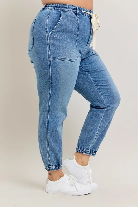 High waist denim joggers standing pose