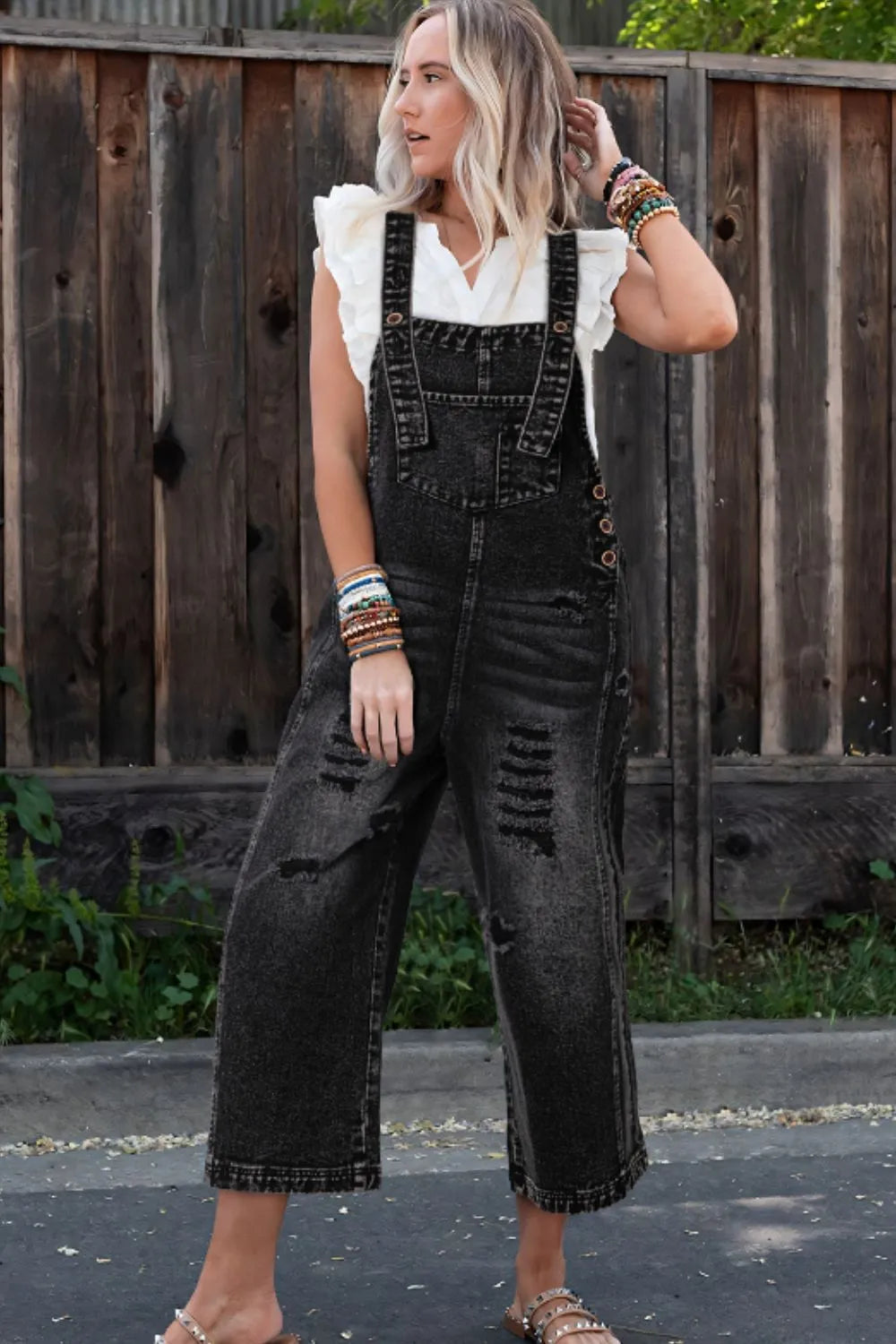 Distressed wide strap black denim overalls front view