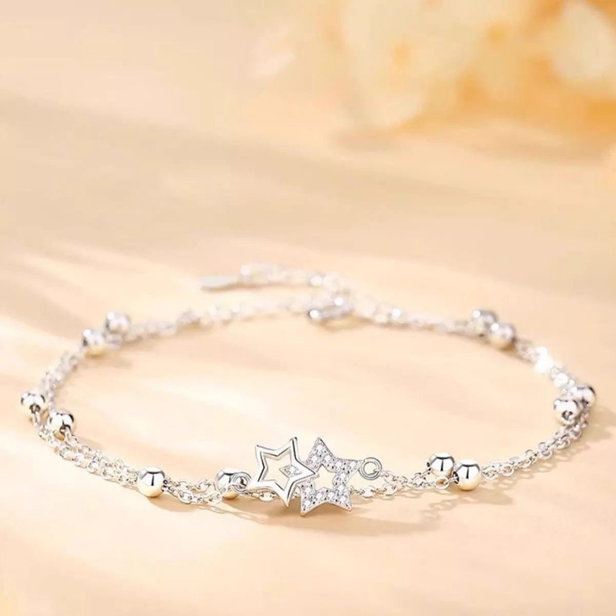 Fine silver chain and clasp detail on the bracelet