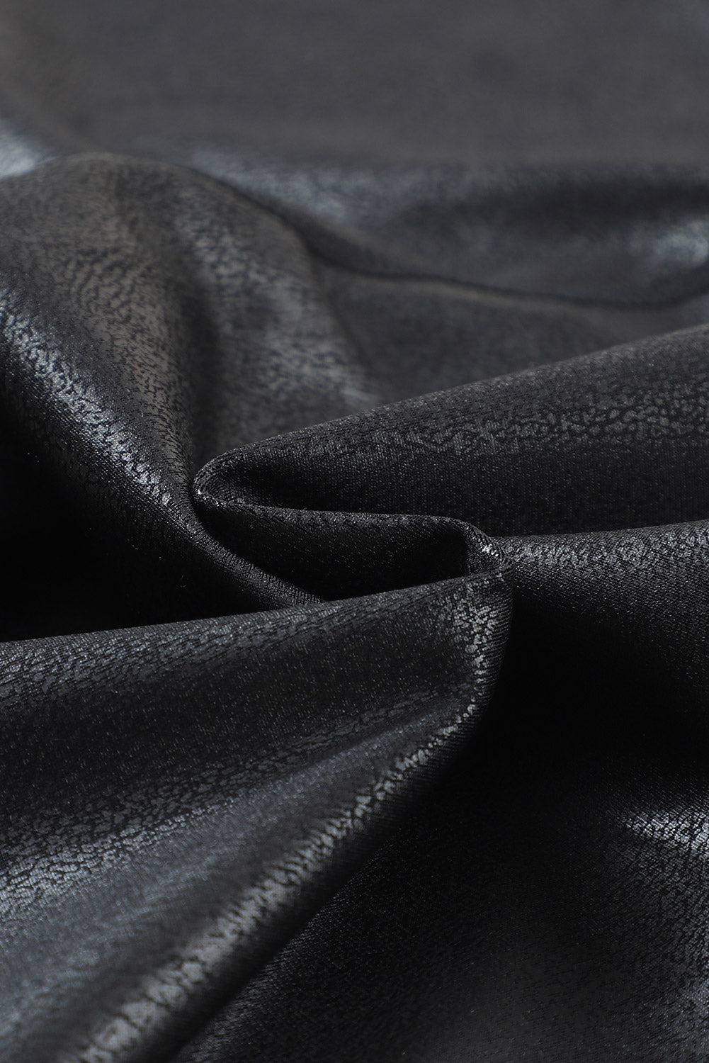Close up of glossy foil embossed faux leather fabric