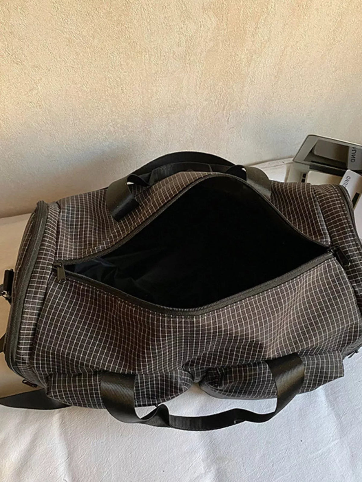 Black plaid duffel bag styled view