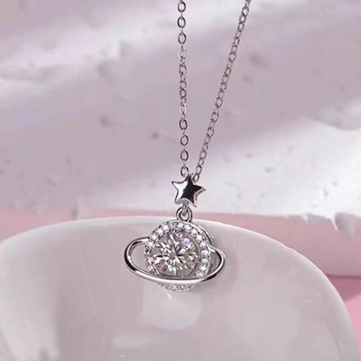 Close up of the moissanite stone in the planet pendant