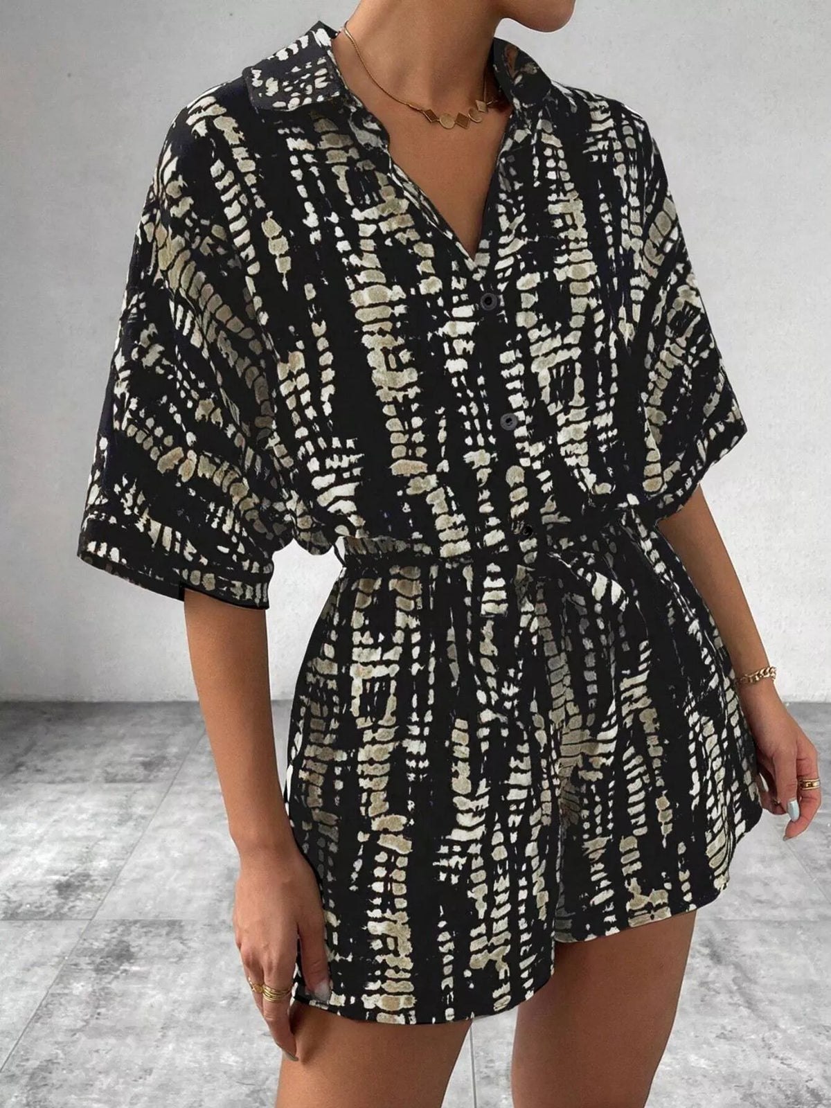 Button up striped romper on model outdoors
