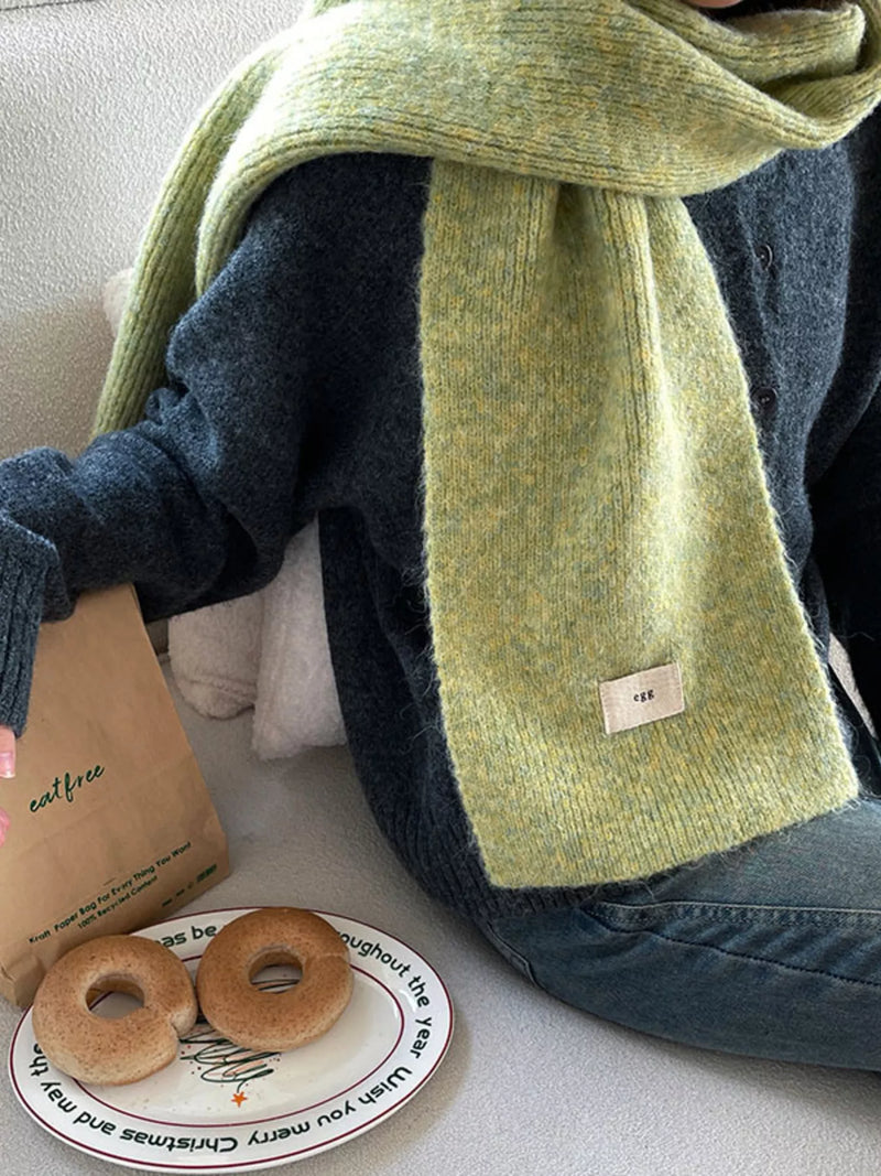 Cozy knitted winter scarf in a soft green tone