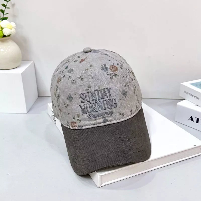 Floral embroidery detail on cotton cap