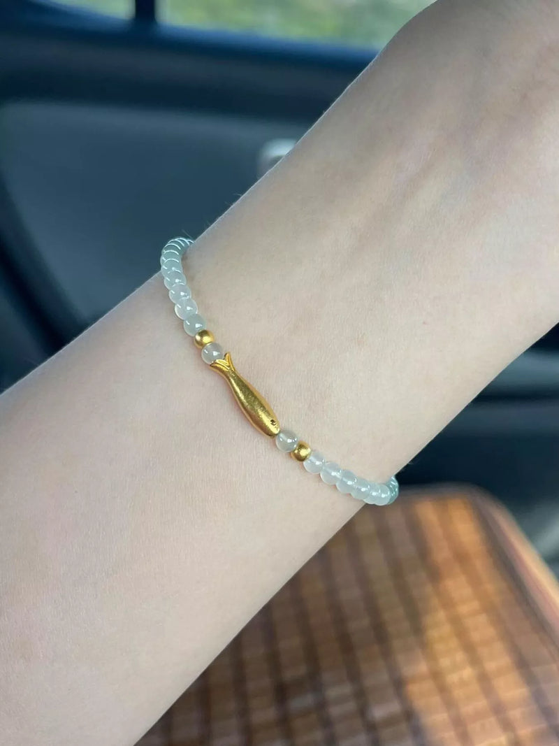 Gold plated fish beaded bracelet on wrist