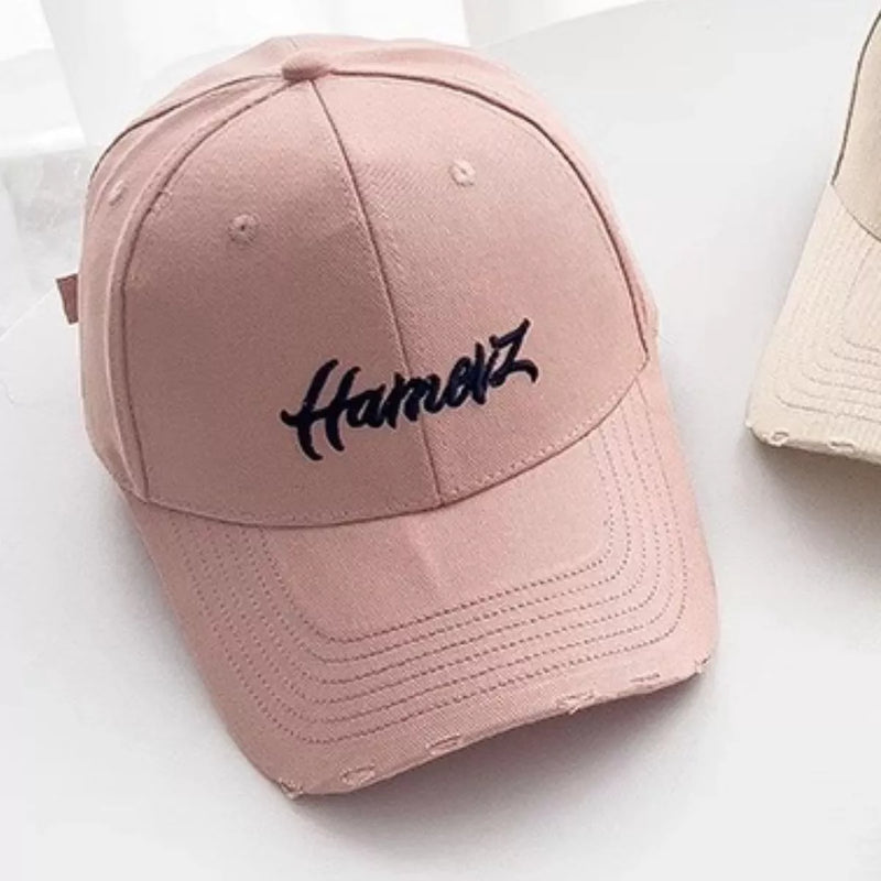 Pink distressed embroidered baseball cap, front view