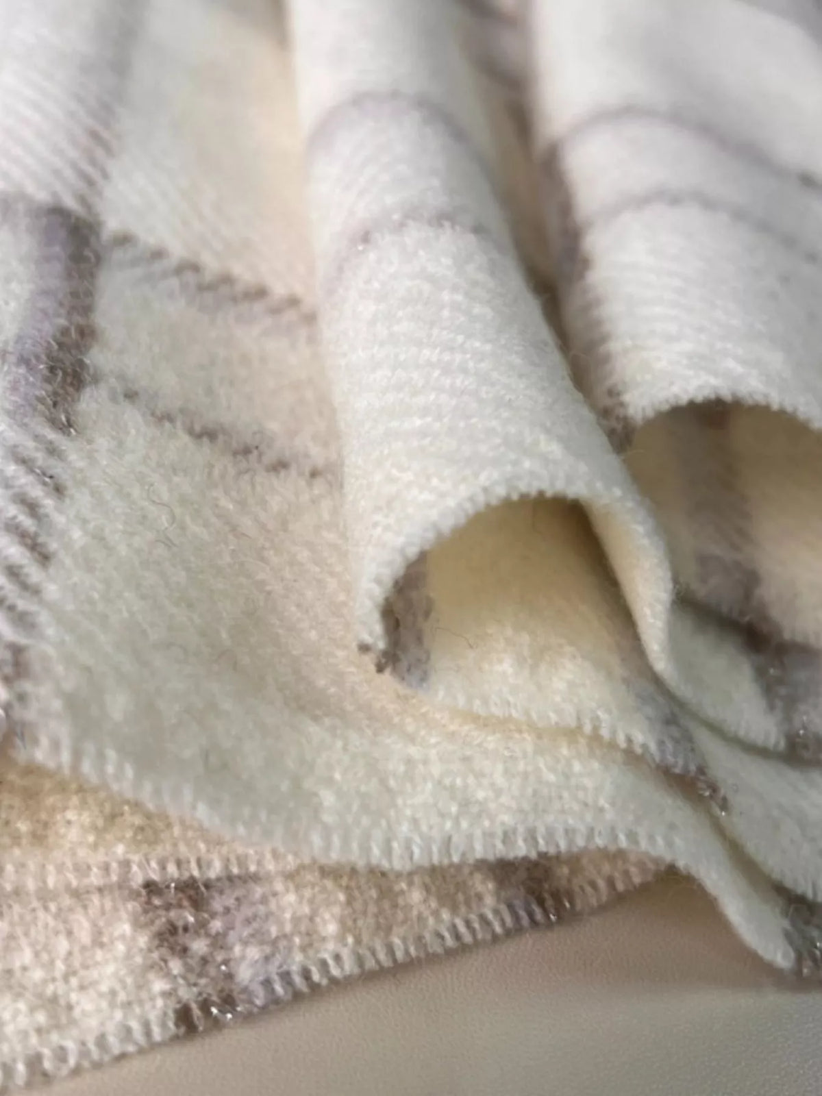 Close up of the plaid weave and raw hem edge