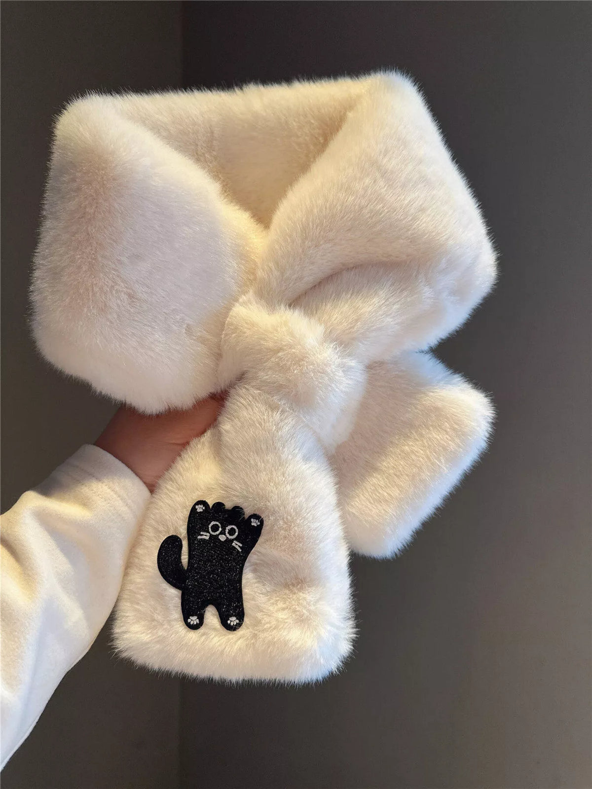 Soft plush scarf with a playful embroidered cat design