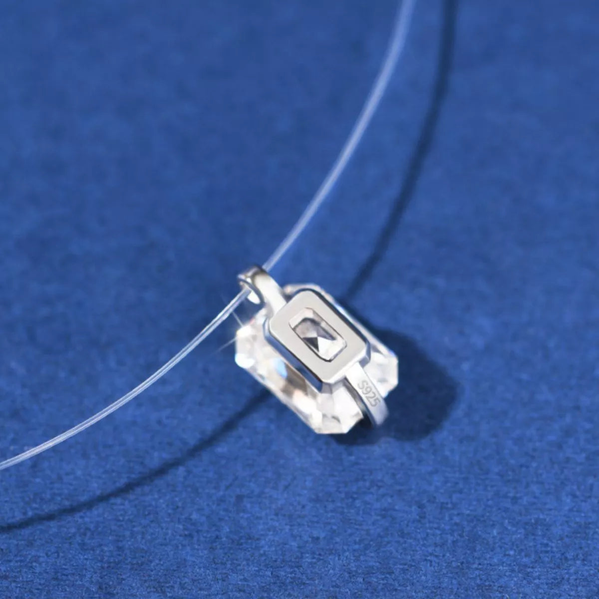 Angled view of moissanite pendant showing fire and sparkle