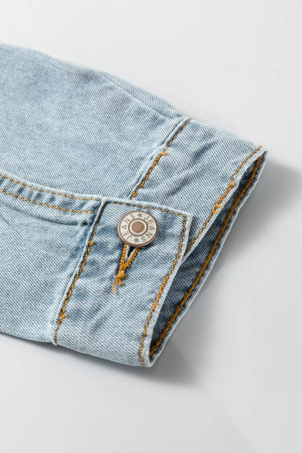 Sleeve and cuff detail on the light wash denim jacket