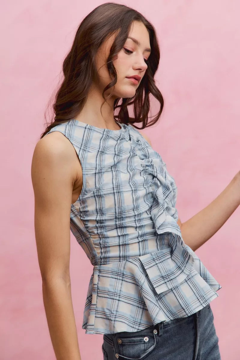 Blue plaid sleeveless ruffle peplum top front view